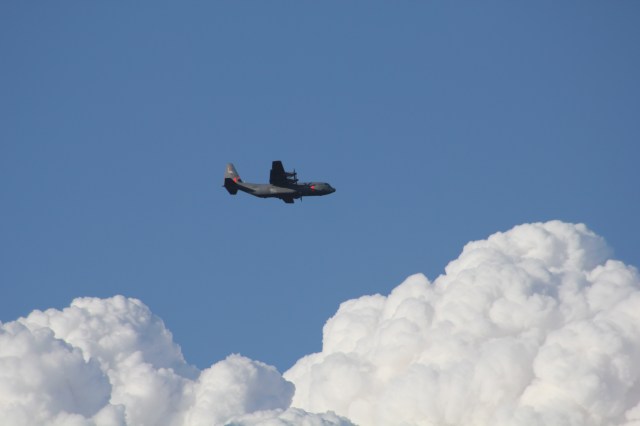 C-130 Against Smoke Clouds